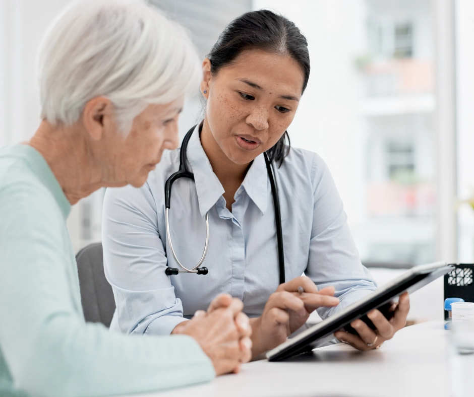 doctor with tablet and senior patient reviewing Medicare changes for 2026